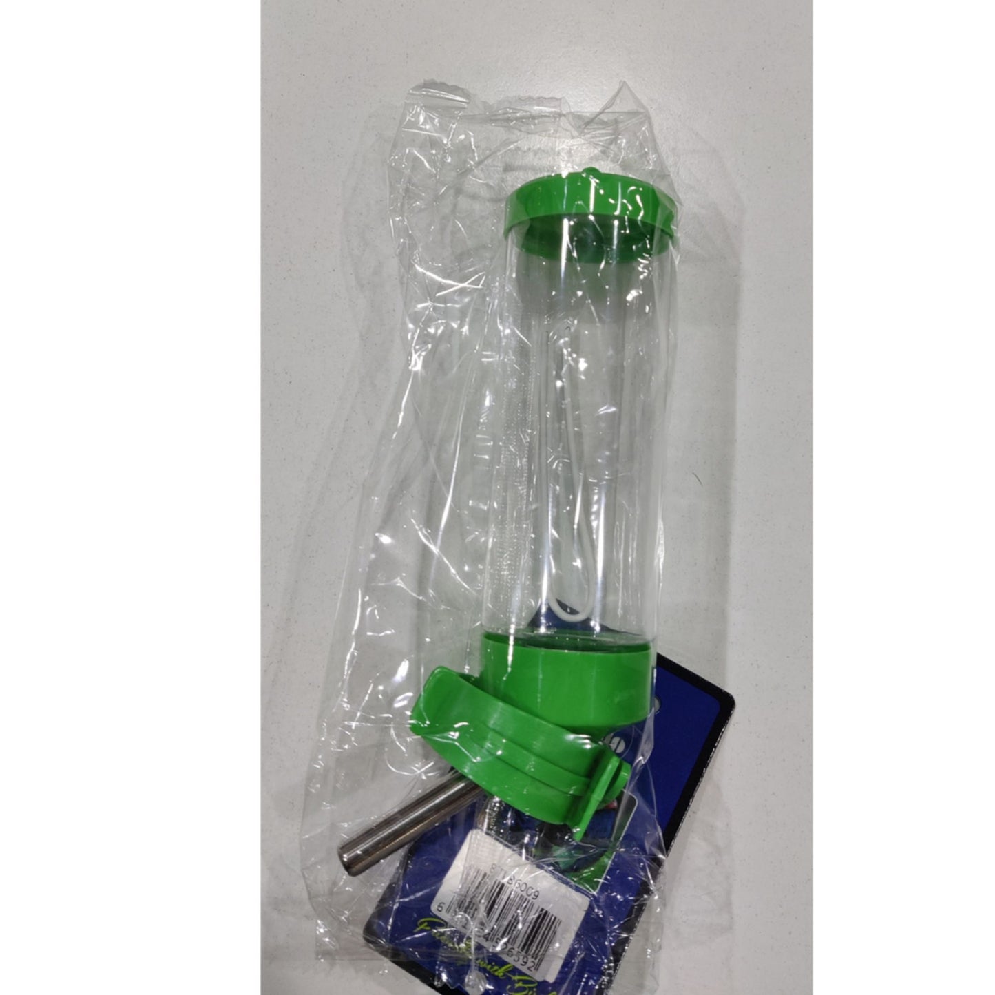 Green and clear plastic component in packaging on a white background