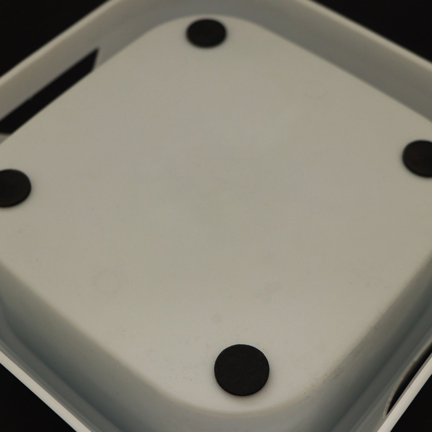 Close-up of a pet bowl with black components on a dark background