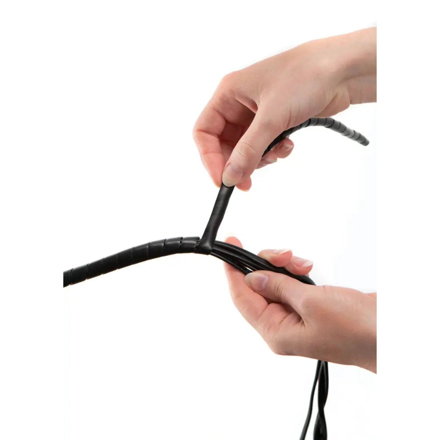 Hand holding a coiled black cable against a white background