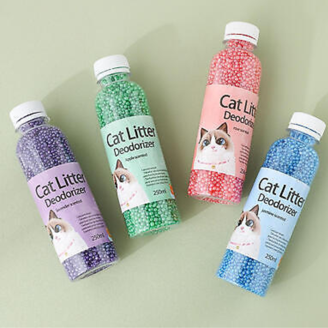 Four bottles of cat litter deodorizer with different colored beads on a light green background