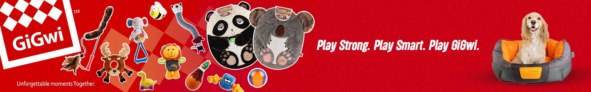 GiGwi dog toys and beds with a variety of colorful plush toys, including panda, koala, lion, and elephant designs. A dog sits in a GiGwi pet bed. Text says: “Play Strong. Play Smart. Play GiGwi.”
