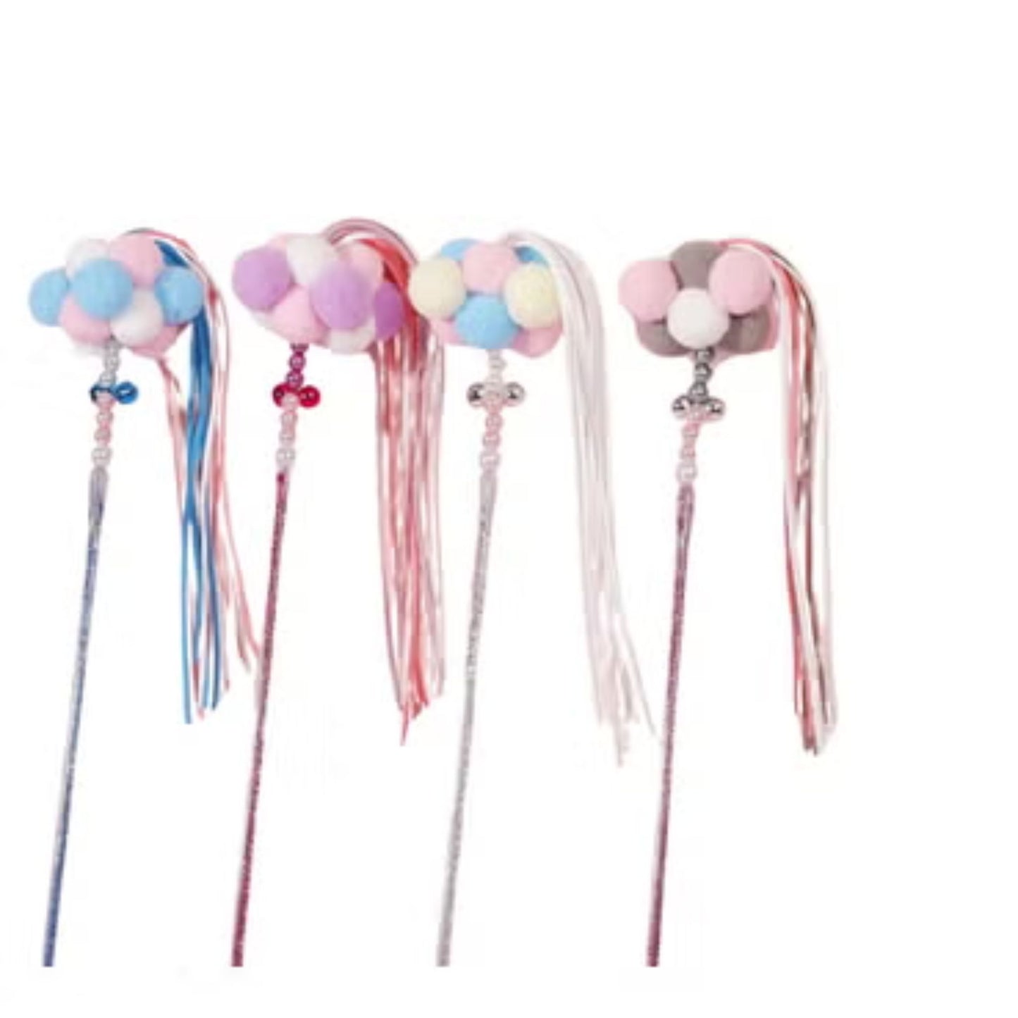 Set of decorative wands with colorful pom-poms and ribbons on a white background