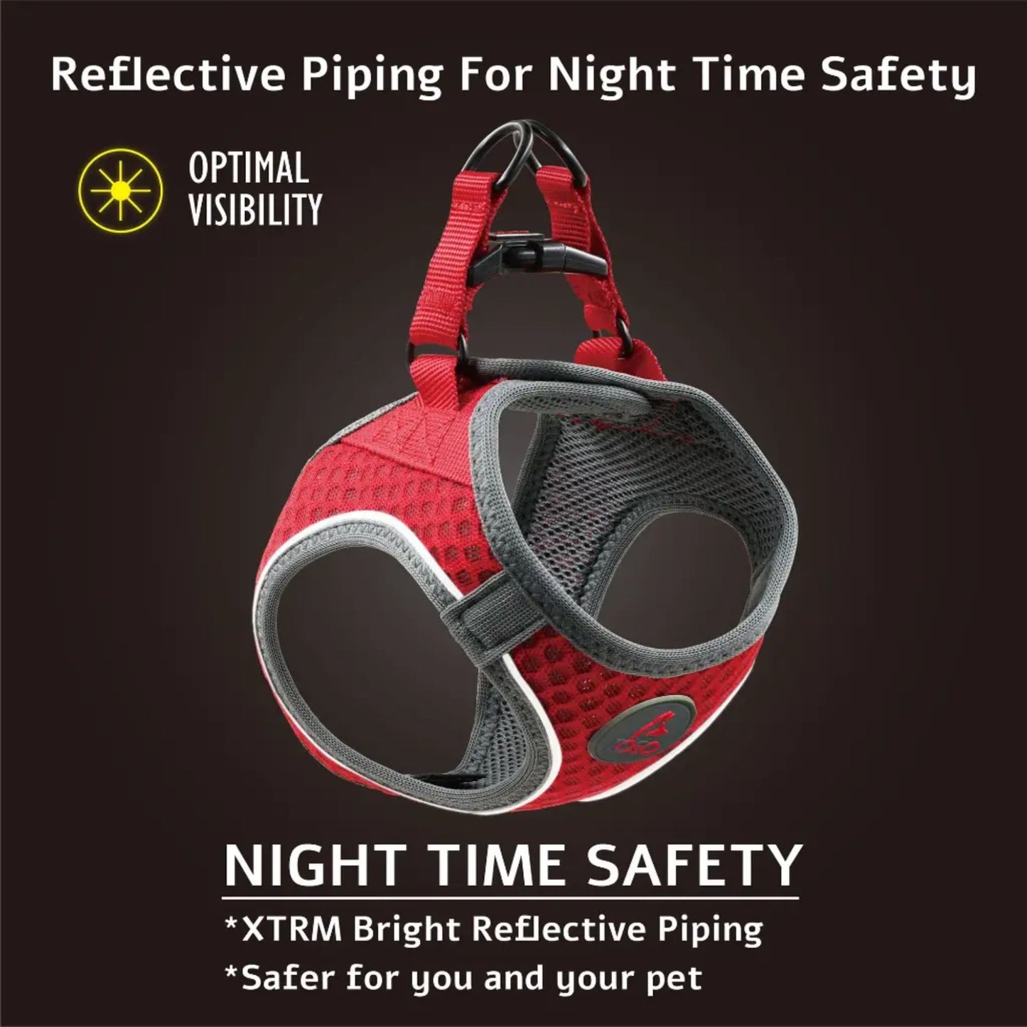 Red and grey dog harness with reflective piping on a dark background