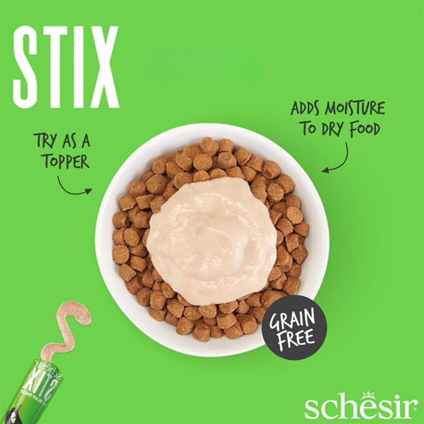 Dog food with a scoop of Schesir Stix on a green background