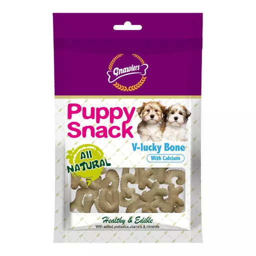 A package of Grawlen Puppy Snack V-lucky Bone dog treats. The packaging features a purple top section with the Grawlen logo, pink 'Puppy Snack' text, and a clear window showing the bone-shaped treats inside.